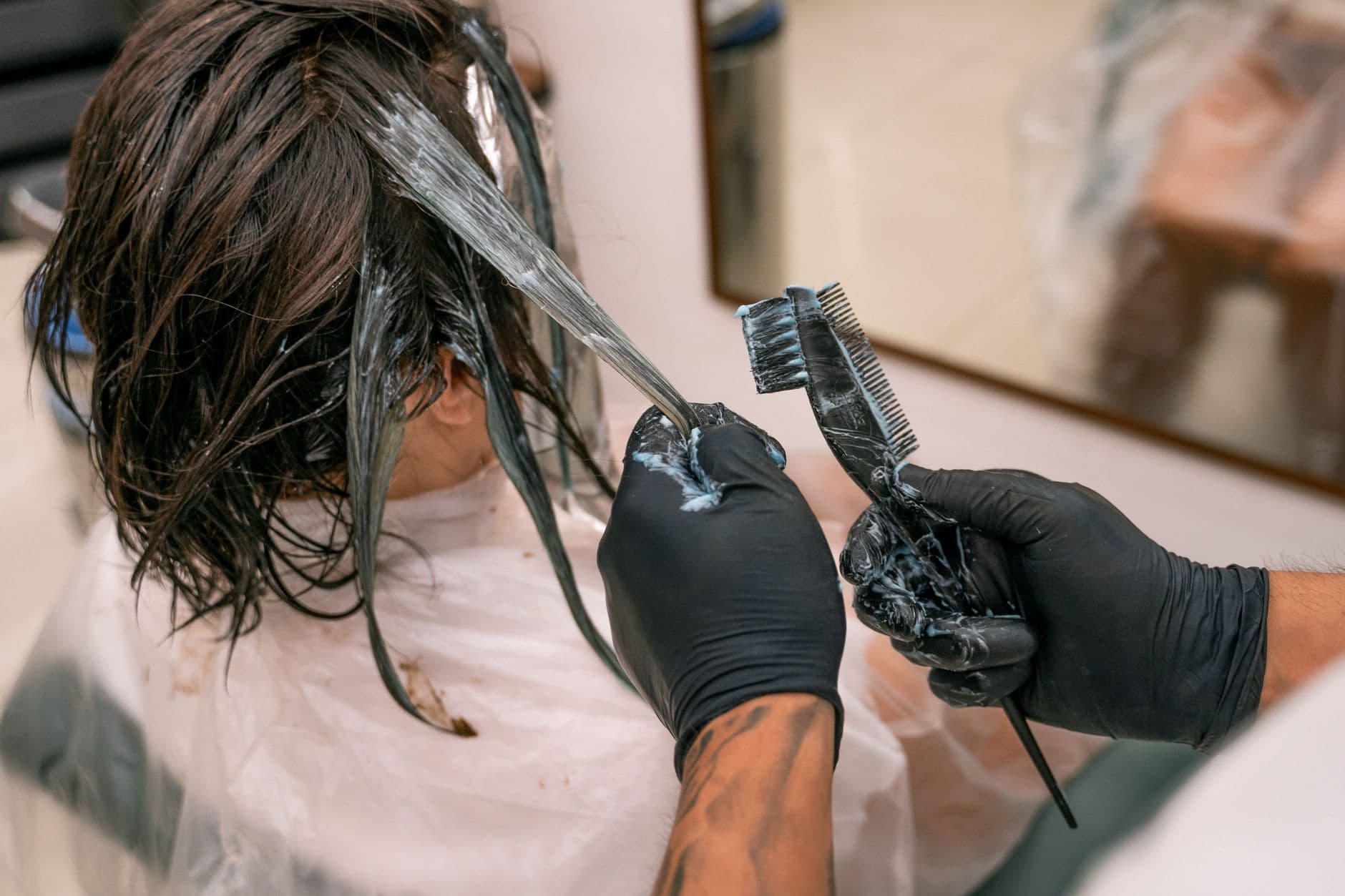 Hair stylist applying a professional treatment to a client's hair