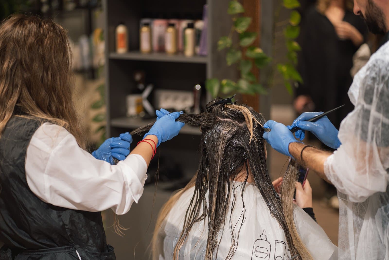 Illustrative Pexels stock photo of stylists applying hair colour in a salon; not a Mosaic client, stylist or result