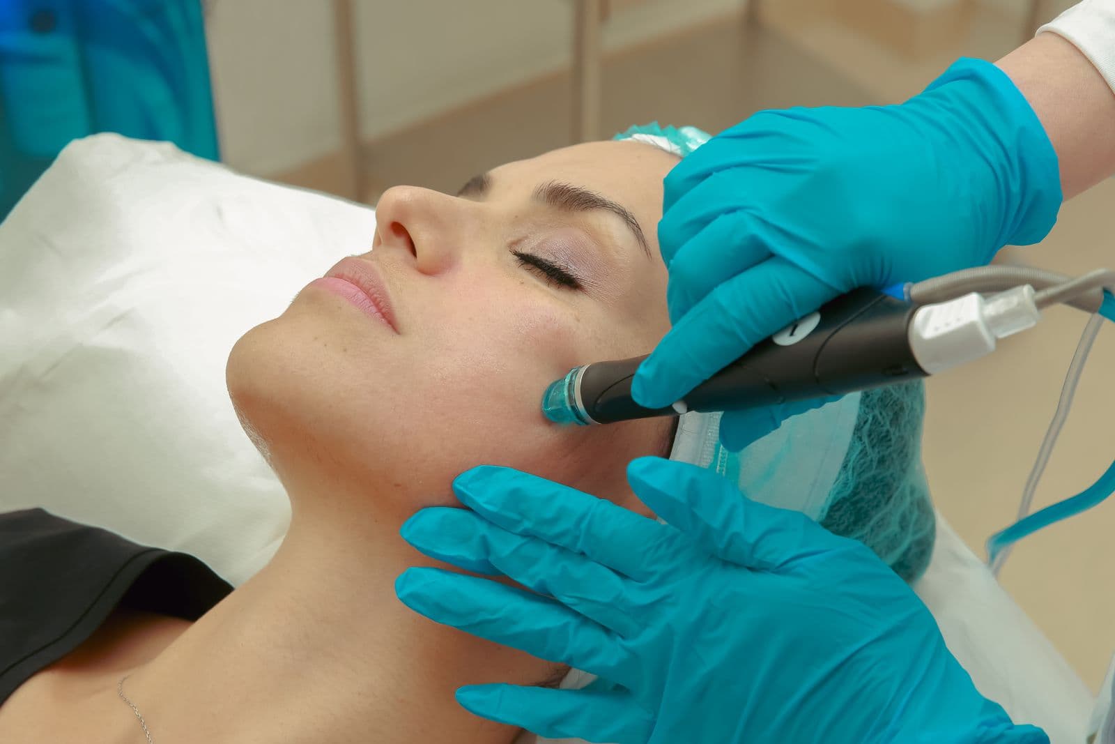 Illustrative Pexels photo of a skin professional using a facial device on a client; not a Mosaic client, provider, or result